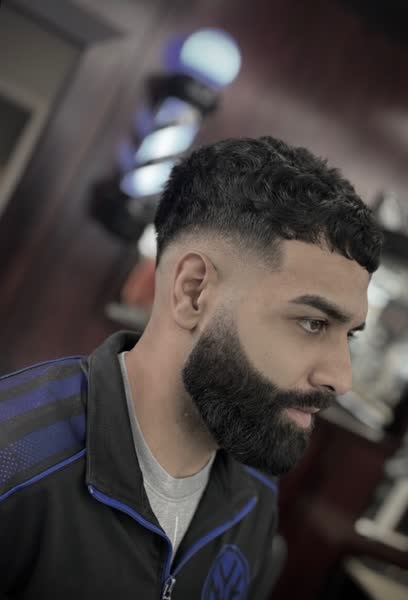 Curly top with a drop fade and full beard shape-up at Salt City Barber Shop in Liverpool, NY